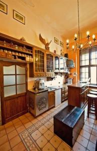 a large kitchen with a stove and a table in it at Zamek Dobra in Oleśnica