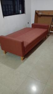 a large wooden bed in a room at Comfortable, bright and compact in Tembladera +3 photos
