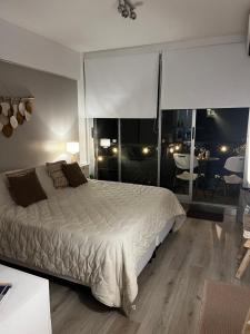 a bedroom with a large bed and a dining room at Urquiza Suite Premium Rental in Buenos Aires