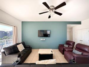 a living room with a couch and a ceiling fan at Stylish Condo Beach & Pool Access E202 in Puerto Peñasco