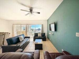 a living room with two couches and a ceiling fan at Stylish Condo Beach & Pool Access E202 in Puerto Peñasco