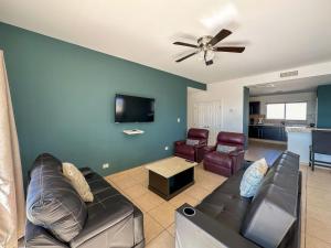 a living room with a couch and a ceiling fan at Stylish Condo Beach & Pool Access E202 in Puerto Peñasco