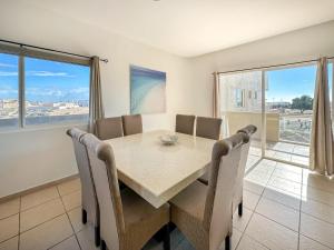 a dining room with a table and chairs at Stylish Condo Beach & Pool Access E202 in Puerto Peñasco
