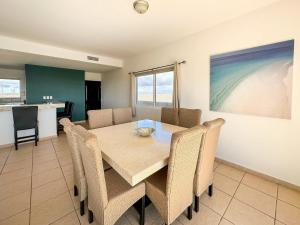 a dining room with a table and chairs at Stylish Condo Beach & Pool Access E202 in Puerto Peñasco +38 photos