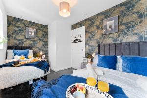 two beds in a room with blue and white at 3-Bedrm, Parking, Soccer Table, Sleeps 7 in Cannock