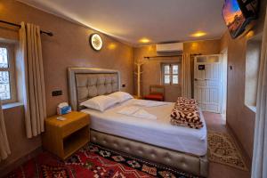 a bedroom with a large bed in a room at Maison Gourdia in Zouiyya +21 photos