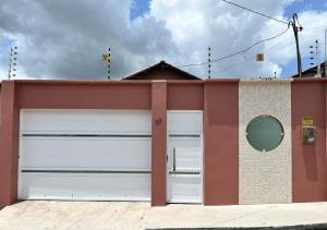 a pair of garage doors on a building at Casa completa em Bragança in Bragança +41 photos