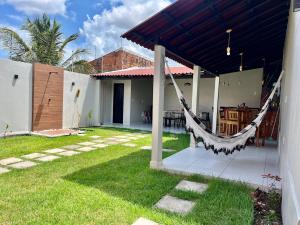 a patio with a hammock hanging from a house at Casa completa em Bragança in Bragança