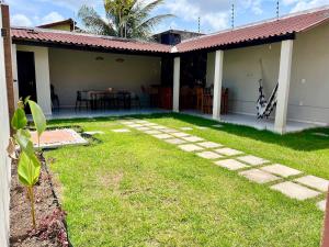 a backyard of a house with a grass yard at Casa completa em Bragança in Bragança