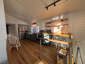 a large kitchen with wooden floors and a counter top at Cozy cabin by the lake in Spring Lake +15 photos