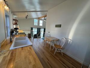 a large living room with a table and chairs at Cozy cabin by the lake in Spring Lake
