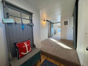a hallway with a door and a red pillow at Cozy cabin by the lake in Spring Lake