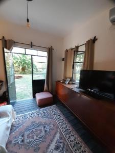 a living room with a piano and a large window at La Chaira in Santa Ana
