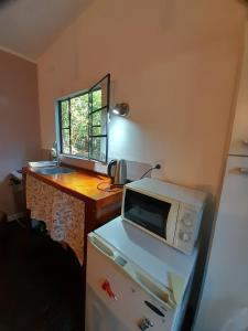 a microwave sitting on top of a counter in a kitchen at La Chaira in Santa Ana