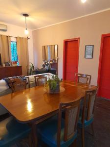 a dining room with a wooden table and chairs at La Chaira in Santa Ana