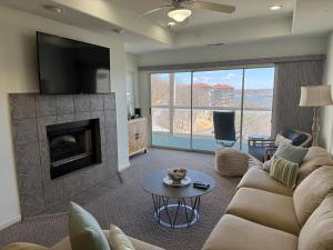 a living room with a couch and a fireplace at Lake Ozarks Get Away Topsider in Lake Ozark