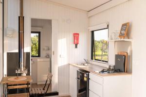 a kitchen with a sink and a stove top oven at The Nest at Arahura Escape by Tiny Away in Kaihinu