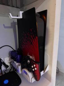 a computer monitor with two remote controls attached to it at N3XT-LEVEL Pool in Praia +11 photos