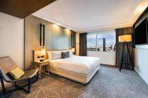 a hotel room with a bed and a chair at PARKROYAL Darling Harbour, Sydney in Sydney +41 photos