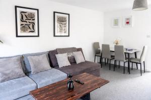a living room with a couch and a table at 3-Bedrm, Parking, Soccer Table, Sleeps 7 in Cannock
