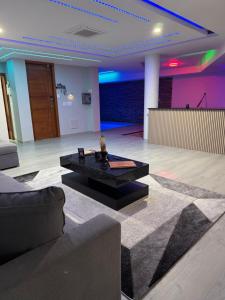 a living room with a couch and a coffee table at N3XT-LEVEL Pool in Praia