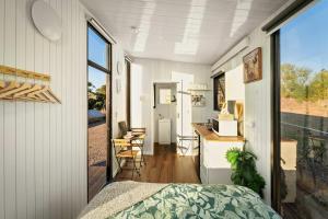 a bedroom with a bed and a desk in a room at Rivergum Lodge by Tiny Away in Scotts Creek