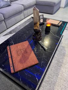 a coffee table with a book on top of it at N3XT-LEVEL Pool in Praia