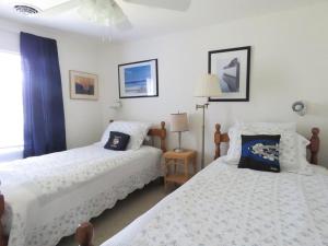 two beds in a room with white walls at Parsons Folly Unit 3 in Cape May Point