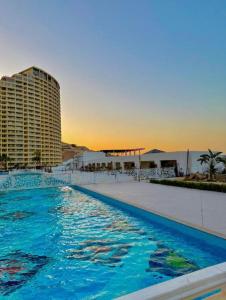 a large swimming pool with a building in the background at Porto El Sokhna in Ain Sokhna
