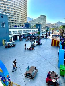 a group of people sitting on benches in a courtyard at Porto El Sokhna in Ain Sokhna