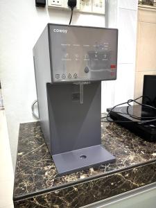 a machine sitting on a counter in a kitchen at M Guest House2 in Muar