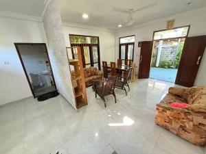 a living room with a couch and a table at Arumathi Villa in Bentota