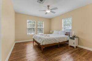 a bedroom with a bed and a ceiling fan at 5 beds 2 bath, sleep 10 in Corpus Christi