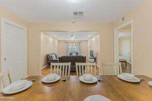 a dining room and living room with a table and chairs at 5 beds 2 bath, sleep 10 in Corpus Christi