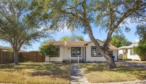 a white house with trees in a yard at 5 beds 2 bath, sleep 10 in Corpus Christi