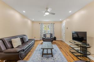 a living room with a couch and a tv at 5 beds 2 bath, sleep 10 in Corpus Christi