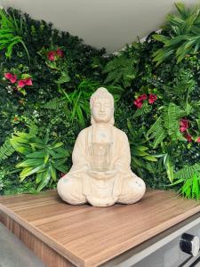 a white statue sitting on a wooden board with a plant at Red Silence I Design Suite im Koblenz in Bendorf
