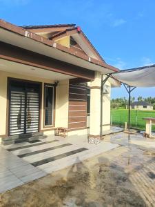 a house with a porch and a patio at D'sawah Guest House in Kota Bharu
