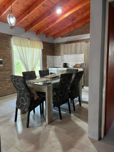 a dining room with a table and some chairs at Cabaña Tres linas in Villa General Belgrano