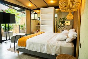 a bedroom with a large bed and a tv at Villajesu Villeta in Villeta