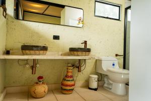 a bathroom with two sinks and a toilet at Villajesu Villeta in Villeta +51 photos