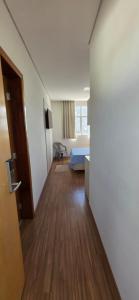 a room with a hallway with a bed and a door at Flats Paris in Lagoa Santa +10 photos