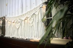 a white fence on a balcony with a plant at 都蘭朋友家 Dulan Friends Hostel in Donghe
