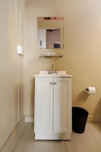 a white bathroom with a sink and a mirror at Colmena Hotel CDMX Centro in Mexico City +26 photos