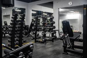 a gym with several rows of squat machines at Pelican Waters Golf Resort Sunshine Coast in Caloundra