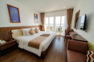 a hotel room with a bed and a television at Ben Tre Riverside Resort in Ben Tre