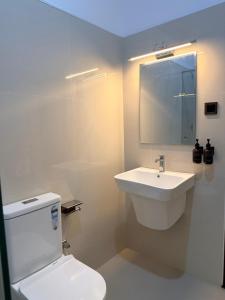 a bathroom with a white toilet and a sink at Mount Crest Inn Deniyaya in Deniyaya +33 photos
