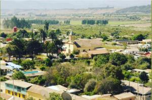 an aerial view of a small town with a church at Casa La Nuez in Algarrobito