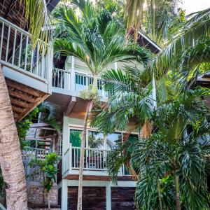 a building with palm trees in front of it at Rawa Island Resort in Mersing