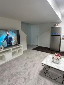 a living room with a large flat screen tv at Lizzy cozy Basement suite in Airdrie